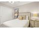 This cozy bedroom features a ceiling fan, nightstands with lamps, and a window to let in natural light at 4111 S Dewdrop Ct, Gilbert, AZ 85297