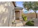 Inviting front entrance with decorative door, desert landscaping, and a walkway leading to the home at 4111 S Dewdrop Ct, Gilbert, AZ 85297