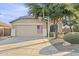 Charming single-story home featuring a two-car garage, beige exterior, and mature landscaping with a basketball hoop at 4111 S Dewdrop Ct, Gilbert, AZ 85297