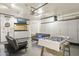 Finished garage with epoxy floors, storage cabinets, and recreational features like a foosball table and tv at 4111 S Dewdrop Ct, Gilbert, AZ 85297