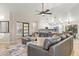 Inviting living room with a leather sectional, open layout, and view into kitchen and secondary room at 4111 S Dewdrop Ct, Gilbert, AZ 85297