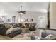 Bright and airy living room with a leather sectional, modern decor, and wood-look floors at 4111 S Dewdrop Ct, Gilbert, AZ 85297