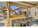 Stylish outdoor bar featuring a corrugated metal roof, wooden beams, and backyard entertainment area at 4111 S Dewdrop Ct, Gilbert, AZ 85297