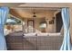 Inviting outdoor patio with comfortable wicker furniture, ceiling fan, and a mounted television at 4111 S Dewdrop Ct, Gilbert, AZ 85297