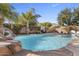 Backyard pool featuring a rock waterfall, palm trees and plenty of space to relax and entertain at 4111 S Dewdrop Ct, Gilbert, AZ 85297