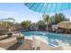 Luxurious pool area with a rock waterfall, waterslide, and tropical landscaping for ultimate relaxation at 4111 S Dewdrop Ct, Gilbert, AZ 85297