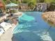 Backyard pool featuring a rock waterfall, hot tub and plenty of space to relax and entertain at 4111 S Dewdrop Ct, Gilbert, AZ 85297