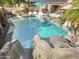 Backyard pool featuring a slide, rock waterfall and plenty of space to relax and entertain at 4111 S Dewdrop Ct, Gilbert, AZ 85297
