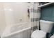 Clean bathroom featuring a shower and jacuzzi tub combination with a toilet and storage at 4216 E Sandia St, Phoenix, AZ 85044