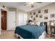 Comfortable bedroom with ceiling fan, stylish bedding, and ample closet space at 4216 E Sandia St, Phoenix, AZ 85044
