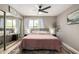 Comfortable bedroom featuring a plush king bed, ceiling fan, and bright window views at 4216 E Sandia St, Phoenix, AZ 85044