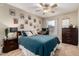 Bedroom with a ceiling fan, decorative wall art, and a comfortable bed at 4216 E Sandia St, Phoenix, AZ 85044