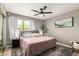 Comfortable bedroom featuring a plush king bed, ceiling fan, and bright window views at 4216 E Sandia St, Phoenix, AZ 85044