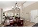 Spacious dining area featuring a modern chandelier, vaulted ceilings, and access to the living room at 4216 E Sandia St, Phoenix, AZ 85044