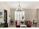 Dining area with modern lighting, plantation shutters, and view of the kitchen at 4216 E Sandia St, Phoenix, AZ 85044