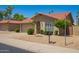 Beautiful home exterior showcasing desert landscaping, terracotta roof, and a charming arched entryway at 4216 E Sandia St, Phoenix, AZ 85044