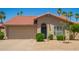 Charming home featuring a terra cotta roof, front yard desert landscaping, and a welcoming blue front door at 4216 E Sandia St, Phoenix, AZ 85044