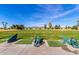 Well-maintained golf course driving range, set against a clear blue sky and mountain backdrop at 4216 E Sandia St, Phoenix, AZ 85044