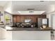 Modern kitchen featuring stainless steel appliances, dark wood cabinetry, and a peninsula counter at 4216 E Sandia St, Phoenix, AZ 85044