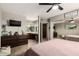 Spacious main bedroom showcasing closet, television, vanity, and large bed with ceiling fan at 4216 E Sandia St, Phoenix, AZ 85044