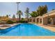 Community pool featuring ample seating, palm trees, and well-maintained landscaping at 4216 E Sandia St, Phoenix, AZ 85044