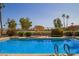 Community pool featuring lounge chairs and beautiful landscaping at 4216 E Sandia St, Phoenix, AZ 85044