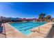 Sparkling swimming pool with blue and red pennants against a clear blue sky at 4216 E Sandia St, Phoenix, AZ 85044
