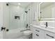 Modern bathroom with a glass-enclosed shower, white vanity, and sleek black fixtures at 4416 E Capistrano Ave, Phoenix, AZ 85044