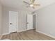Neutral bedroom with a ceiling fan, hardwood floors and white doors at 4416 E Capistrano Ave, Phoenix, AZ 85044