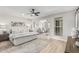 Comfortable main bedroom with a ceiling fan, hardwood floors and ample natural light at 4416 E Capistrano Ave, Phoenix, AZ 85044