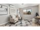 Sitting area with two armchairs featuring natural light, artwork, and neutral colors at 4416 E Capistrano Ave, Phoenix, AZ 85044