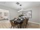 Stylish dining room featuring a modern light fixture and seating for six at 4416 E Capistrano Ave, Phoenix, AZ 85044