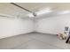 Spacious garage with painted floor, white walls and door leading to the interior of the property at 4416 E Capistrano Ave, Phoenix, AZ 85044