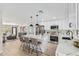 Open kitchen with white cabinets, stainless steel appliances, and island with seating at 4416 E Capistrano Ave, Phoenix, AZ 85044