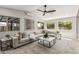 Spacious living room featuring a vaulted ceiling, modern furniture, and ample natural light at 4416 E Capistrano Ave, Phoenix, AZ 85044