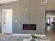 Living room features linear fireplace, wood accent wall, and stylish modern design at 4416 E Capistrano Ave, Phoenix, AZ 85044
