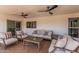 Covered patio featuring comfortable seating, ceiling fans, and tile flooring for outdoor relaxation at 4416 E Capistrano Ave, Phoenix, AZ 85044
