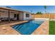 Backyard pool featuring patio, lounge area, wooden fence, and landscaping at 4416 E Capistrano Ave, Phoenix, AZ 85044