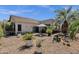 Beautiful backyard with covered patio, decorative rock landscaping and mature foliage at 4680 E Nightingale Ln, Gilbert, AZ 85298