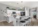 Stylish kitchen with white cabinets, a breakfast bar, modern lighting, and updated appliances at 4680 E Nightingale Ln, Gilbert, AZ 85298