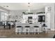 Modern kitchen featuring white cabinets, a marble countertop island with seating, and stainless steel appliances at 4680 E Nightingale Ln, Gilbert, AZ 85298