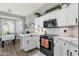 Modern kitchen features white cabinets, stainless steel appliances, and a stylish breakfast nook at 4680 E Nightingale Ln, Gilbert, AZ 85298