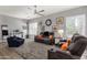 Open-concept living room boasts great natural light, with modern furniture and a ceiling fan at 4680 E Nightingale Ln, Gilbert, AZ 85298