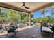 Cozy covered patio with dining and seating area, overlooking the sparkling pool and lush landscape at 4680 E Nightingale Ln, Gilbert, AZ 85298