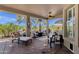 Relaxing covered patio with comfortable furniture and a serene view of the landscaped backyard at 4680 E Nightingale Ln, Gilbert, AZ 85298