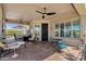 Stylish covered patio with multiple seating areas and scenic views of the lush backyard at 4680 E Nightingale Ln, Gilbert, AZ 85298