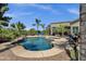 Inviting backyard pool and patio area with desert landscaping and waterfall feature at 4680 E Nightingale Ln, Gilbert, AZ 85298
