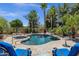 Beautiful pool area with spa, water feature, lounge chairs, and tropical landscaping at 4680 E Nightingale Ln, Gilbert, AZ 85298
