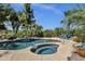 Stunning pool and spa surrounded by lush greenery, creating a private backyard oasis at 4680 E Nightingale Ln, Gilbert, AZ 85298