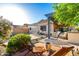 An expansive backyard with a pergola, outdoor kitchen, pool, and lush greenery at 5113 W Molly Ln, Phoenix, AZ 85083